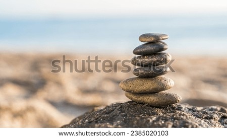 Rock stone stack balance pyramid on sand beach seaside, Symbol of Zen meditation and health