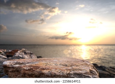 Rock stone stage in nature with sea beach seashore landscape and sunset sky nature background well editing montage Displays product