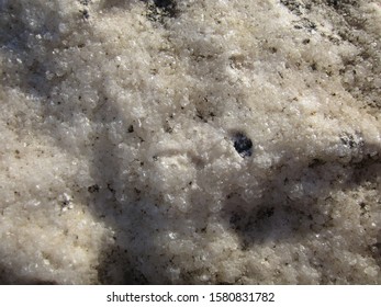 A rock surface with lot of small crystals