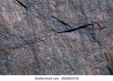 Rock texture. Stone background. Old weathered crumbling mountain surface in cracks background. Light brown rock background.