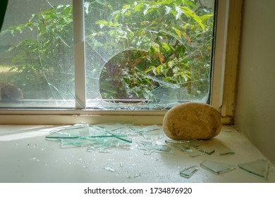 A rock thrown through a window