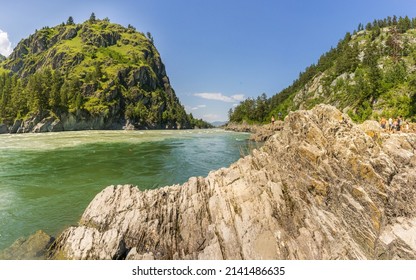 Rock, turquoise water of the Katun river and mountains in summer