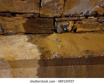 Rock Wall With Water Leak And Mud