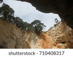 Rock window with trees and blue sky, Apulia, Italy, April 2014.