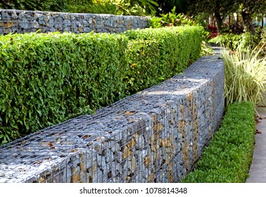 Rock And Wire Gabions Used As Retaining Walls In A Multi Tiered Garden Design 