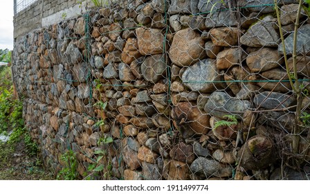 Rock And Wire Gabions Used As Retaining Walls In A Multi Tiered Garden Design