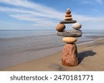 Rock zen pyramid of stones of different shapes on the beach. Concept of Life balance, harmony and meditation