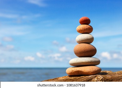 Rock zen pyramid of white and pink stones on the beach. Concept of balance, harmony and meditation