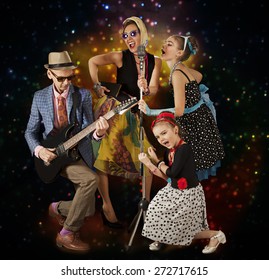 Rockabilly Family Band Playing Music And Singing On A Black Background With Glowing Lights

