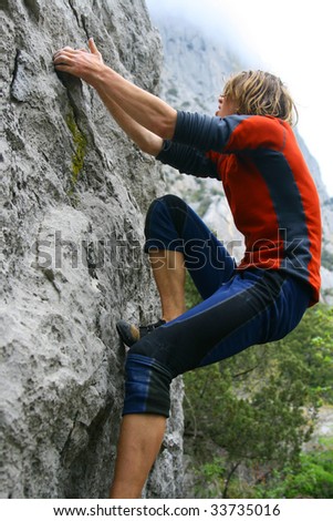 Similar – Rock climber clinging to a cliff.