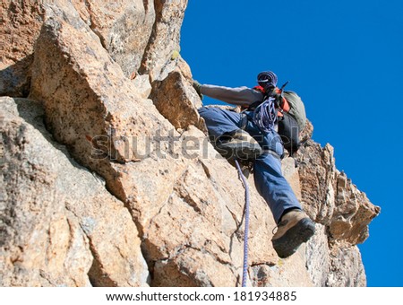 Similar – Image, Stock Photo Rock climber clinging to a cliff.