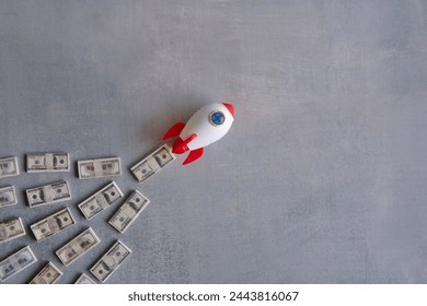 Rocket blasts off through a pile of money. Skyrocket sales, growing sales concept.