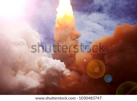 Rocket and clouds. The elements of this image furnished by NASA.