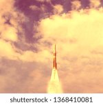 Rocket and clouds. Taking off from ground, lift off. The elements of this image furnished by NASA.