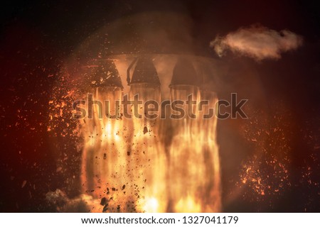 Rocket engines and fire duting the missile launch at night, close up. Elements of this image furnished by NASA.