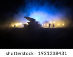 Rocket launch with fire clouds. Battle scene with rocket Missiles with Warhead Aimed at Gloomy Sky at night. Soldiers and Rockets War Backgound. Selective focus