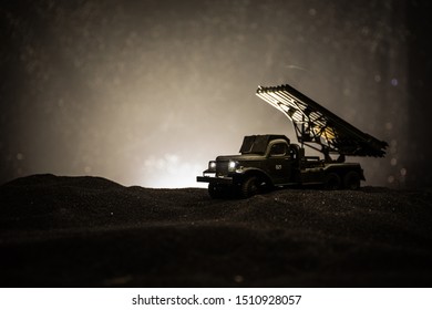Rocket launch with fire clouds. Battle scene with rocket Missiles with Warhead Aimed at Gloomy Sky at night. Soviet rocket launcher on War Background. Creative composition.