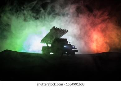 Rocket launch with fire clouds. Battle scene with rocket Missiles with Warhead Aimed at Gloomy Sky at night. Soviet rocket launcher on War Background. Creative composition.