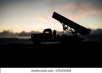 Rocket launch with fire clouds. Battle scene with rocket Missiles with Warhead Aimed at Gloomy Sky at sunset. Soviet rocket launcher on War Background. Creative composition.