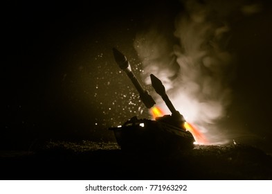 Rocket launch with fire clouds. Battle scene with rocket Missiles with Warhead Aimed at Gloomy Sky at night. Rocket vehicle on War Backgound. Selective focus