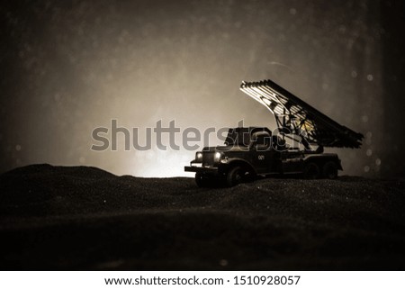 Rocket launch with fire clouds. Battle scene with rocket Missiles with Warhead Aimed at Gloomy Sky at night. Soviet rocket launcher on War Background. Creative composition.