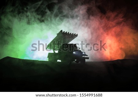 Rocket launch with fire clouds. Battle scene with rocket Missiles with Warhead Aimed at Gloomy Sky at night. Soviet rocket launcher on War Background. Creative composition.