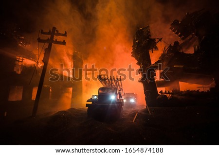 Rocket launch with fire clouds. Battle scene with rocket Missiles with Warhead Aimed at Gloomy Sky at night. Soviet rocket launcher on War Background. Creative composition.