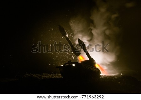 Rocket launch with fire clouds. Battle scene with rocket Missiles with Warhead Aimed at Gloomy Sky at night. Rocket vehicle on War Backgound. Selective focus