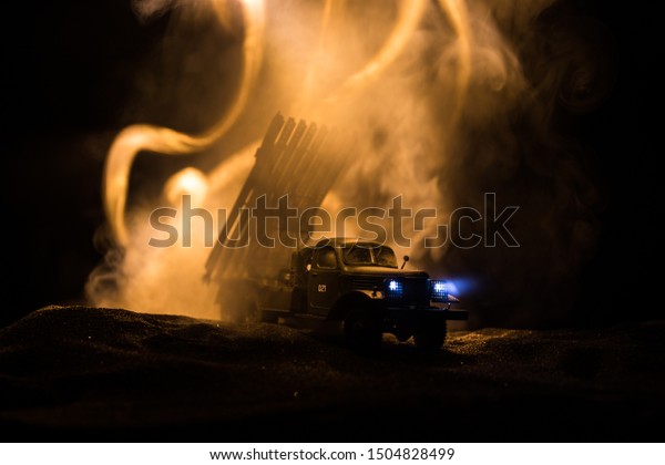 Rocket launch with fire
clouds. Battle scene with rocket Missiles with Warhead Aimed at
Gloomy Sky at night. Soviet rocket launcher on War Background.
Creative composition.