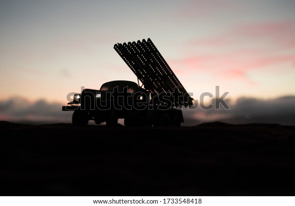 Rocket launch with\
fire clouds. Battle scene with rocket Missiles with Warhead Aimed\
at Gloomy Sky at sunset. Soviet rocket launcher on War Background.\
Creative composition.
