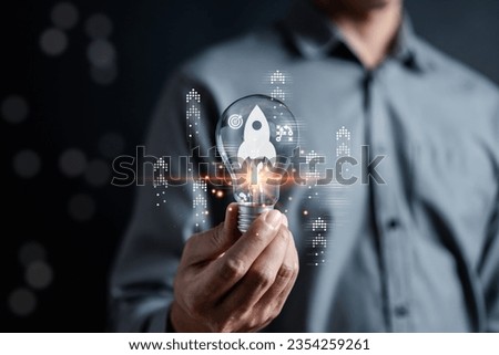 Rocket launch idea inside lightbulb with arrows up. strategically planning and initiating a corporate startup. aim to achieve objectives through value development, fostering leadership.