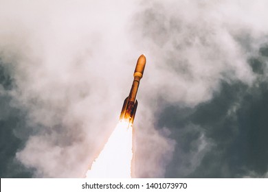 Rocket launch into dramatic sky. The elements of this image furnished by NASA.
 - Powered by Shutterstock