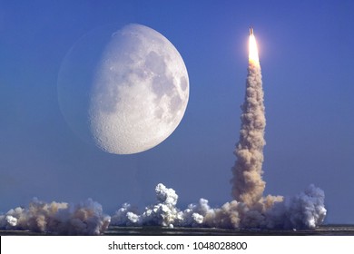 Rocket launch with moon on background. Elements of this image furnished by NASA - Shutterstock ID 1048028800