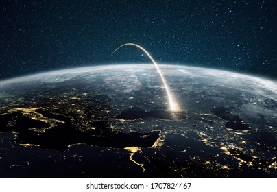 Rocket Launch On A Night Planet Earth With Lights. Concept Of Successful Satellite Launch. Spaceship Flies Over The Planet. View From Space