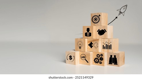 Rocket launching from wood cube with business icon, Start-up, Creativity, Big idea, Business goals management, Investment on new project to wealth, Company strategy target, Sustainable financial plan - Powered by Shutterstock