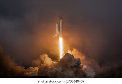Rocket liftoff. Shuttle spaceship launch in the clouds sky. Spaceship begins the mission. Space shuttle taking off on a mission. Concept space travel to mars
				