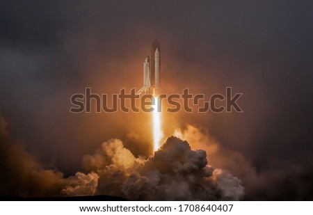 Rocket liftoff. Shuttle spaceship launch in the clouds sky. Spaceship begins the mission. Space shuttle taking off on a mission. Concept space travel to mars
