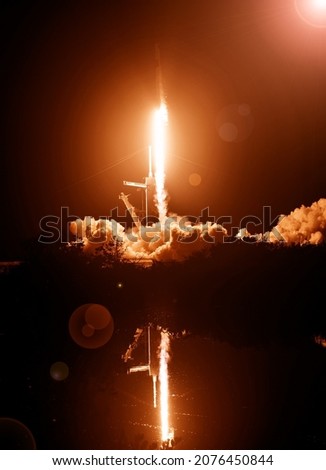 Rocket and light. The elements of this image furnished by NASA.