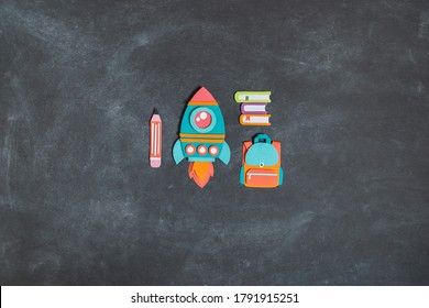 Rocket paper craft as Back to school education. Business startup concept. Paper creativity Black chalkboard background - Powered by Shutterstock