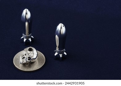 Rocket, skull, bullet. Objects isolated. Piece of money, bullet, braincase on a black background. Metal objects. Scull, cranium, pericranium, coin. Rocket, pellet, ball, missile. 