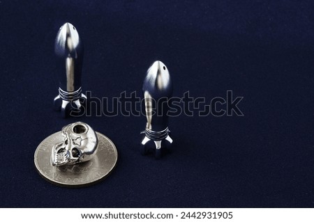Rocket, skull, bullet. Objects isolated. Piece of money, bullet, braincase on a black background. Metal objects. Scull, cranium, pericranium, coin. Rocket, pellet, ball, missile. 