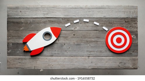 Rocket as a sumbol of high risky goals success targeting at red target at meeting table - Shutterstock ID 1916558732