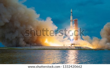 Rocket takes off into the sky. Lots of smoke and gas. The elements of this image furnished by NASA.