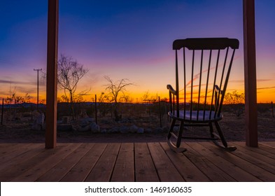 Rocking Chair On The Front Porch During A Sunset