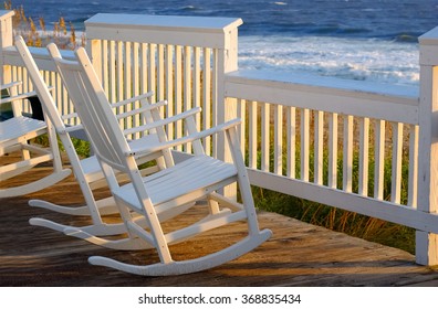 Rocking Chairs On A Porch Over Looking The Beach