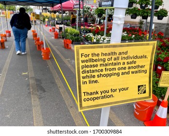 Rocklin, CA - April 8, 2020: Home Depot Entrance Signs About Safe Shopping During The COVID-19 Pandemic, Where Customers Lineup To Get Inside The Store.