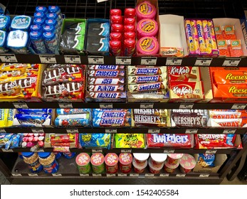 Rocklin, CA - October 22, 2019: Lots of candy bars, chips and gum at a check out register inside a store. 