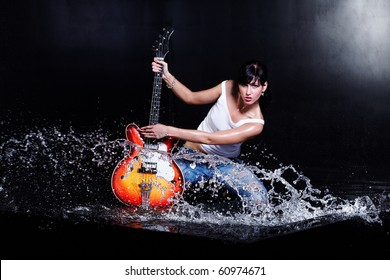 Rock-n-roll Girl Playing A Guitar In Water On Black