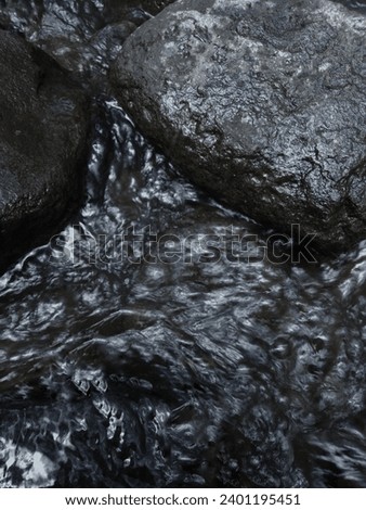 rocks between fast flowing water