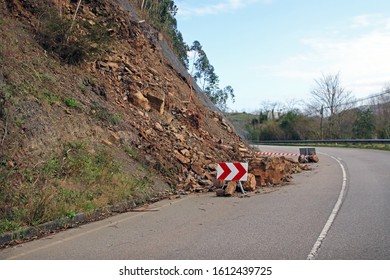 Rocks Blocking The Road Due To A Slope Slide. Landslide In A Concrete Road Produced By Commercial Logging And Tree Felling. Eucaliptus Tree Cutting For Industrial Wood Causes Falling Boulders. Spain. 